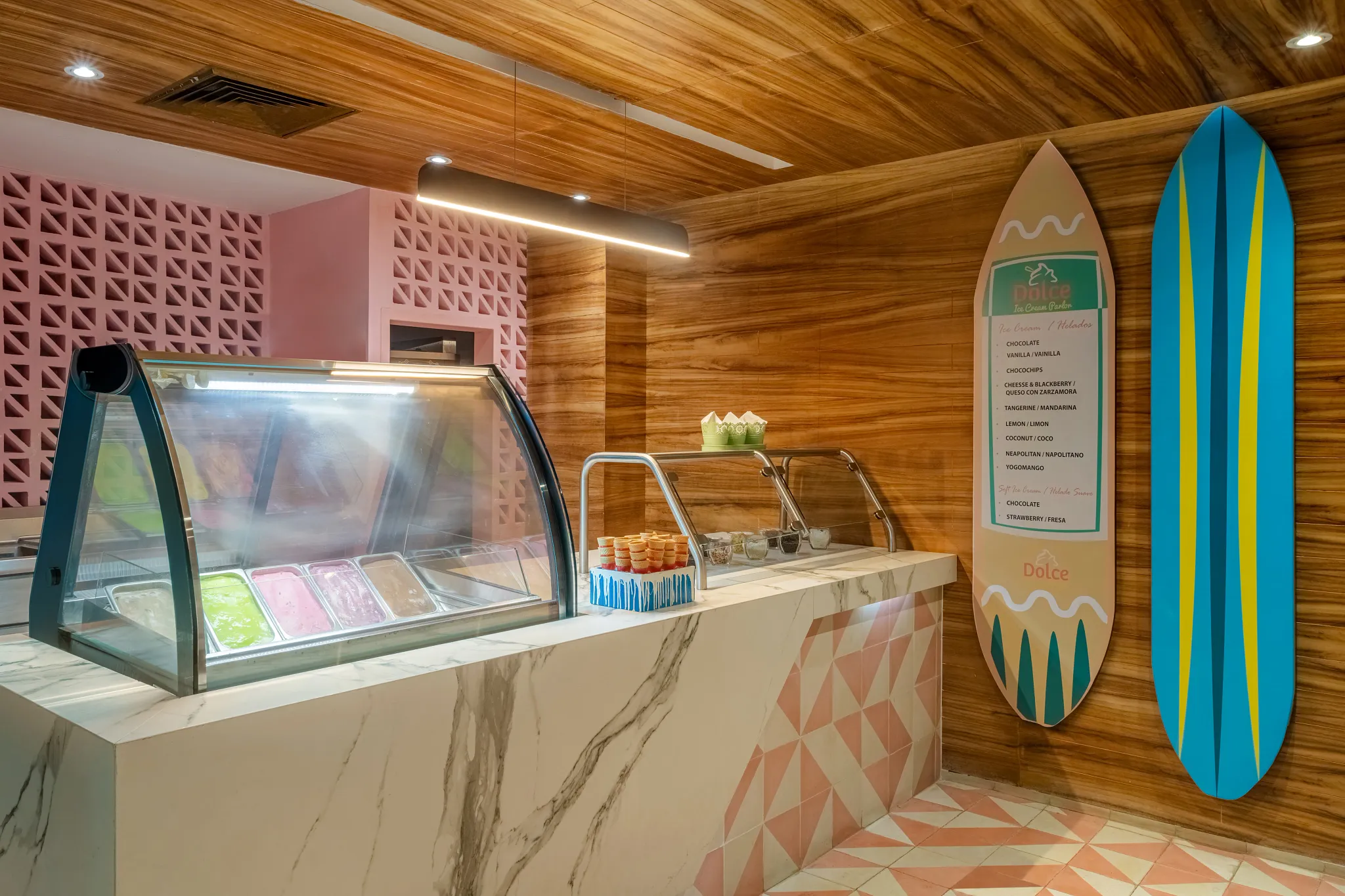 Dolce Ice Cream Parlor at Dreams Acapulco Resort & Spa featuring a colorful gelato display, marble counter, and casual dessert setting.