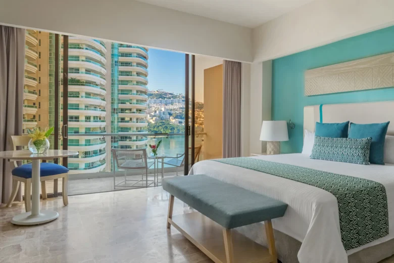 Junior Suite Ocean Front with king bed and private balcony at Dreams Acapulco Resort & Spa overlooking Acapulco Bay.