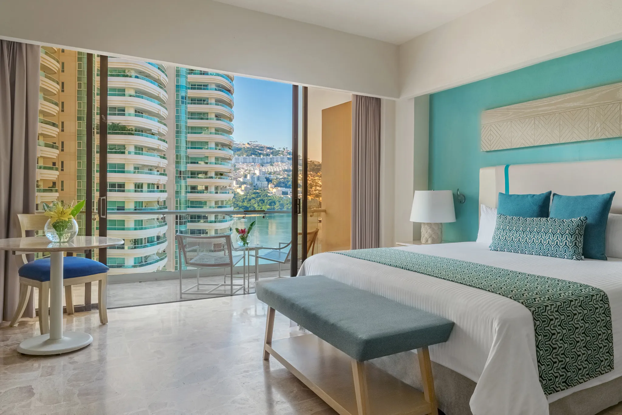 Junior Suite Ocean Front with king bed and private balcony at Dreams Acapulco Resort & Spa overlooking Acapulco Bay.