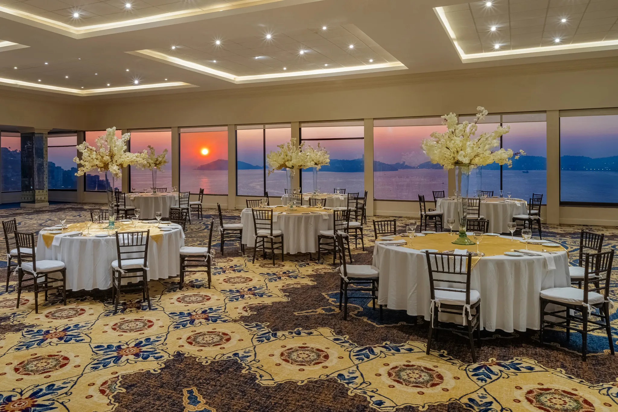 Ballroom event setup with ocean sunset views at Dreams Acapulco Resort & Spa