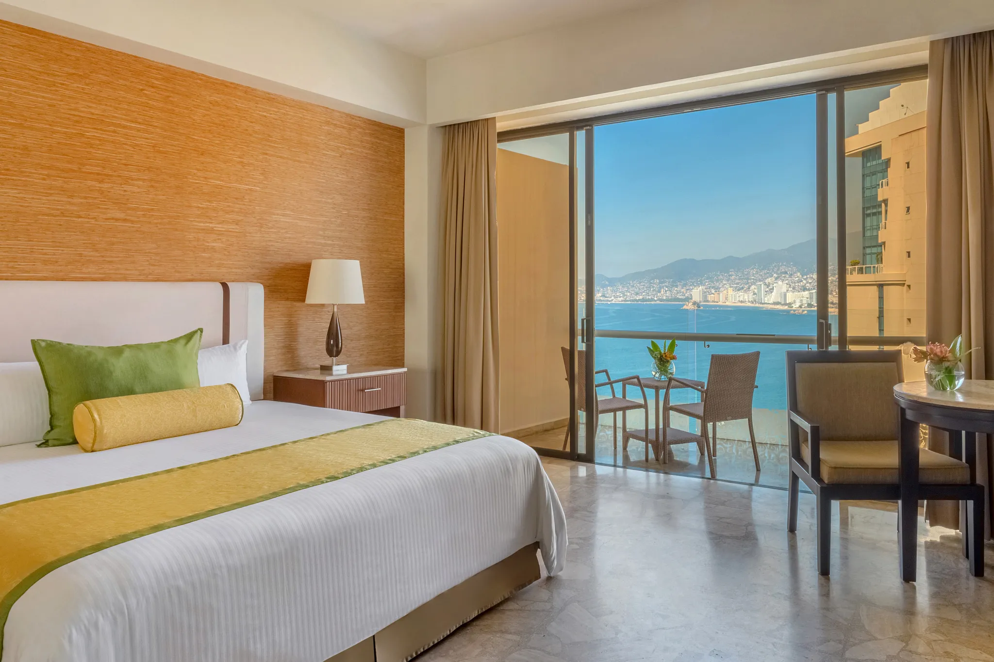 Preferred Club Deluxe Partial Ocean View room with king bed and private balcony at Dreams Acapulco Resort & Spa.