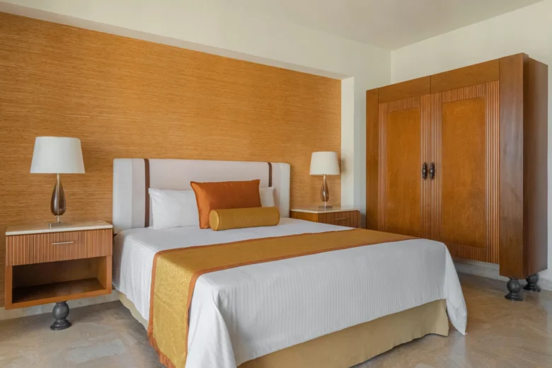 Preferred Club Junior Suite Ocean Front bedroom with king bed at Dreams Acapulco Resort & Spa.